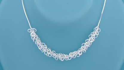 SPC LOTS OF TINY RINGS COBRA CHAIN     =